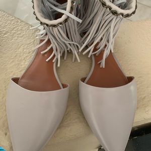 Fun fringe with chain detail pointy flats .